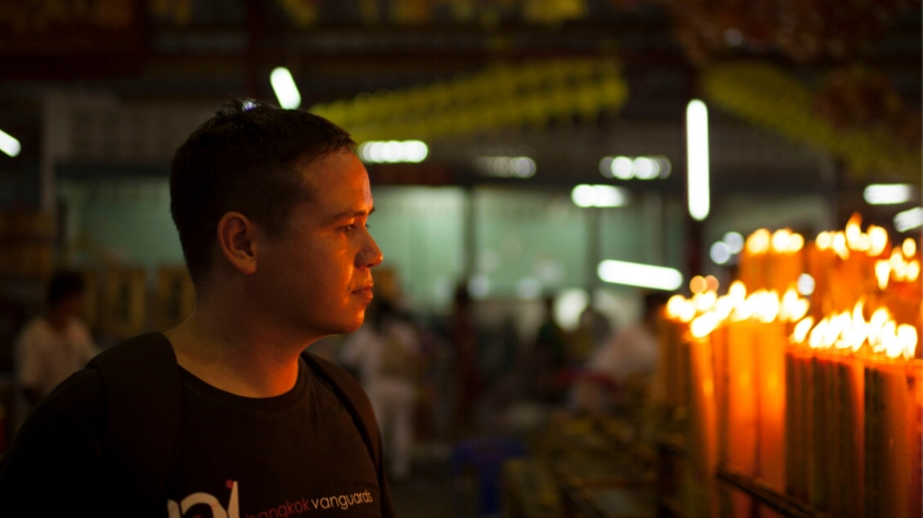 Michael Biedassek contemplating the future of his business while staring at burning candles in Chinatown